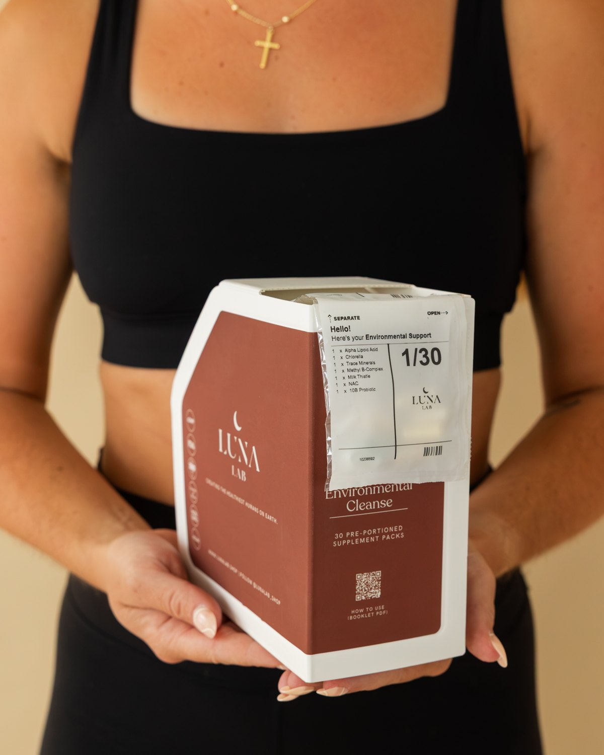 Woman holding the Complete Environmental Cleanse box