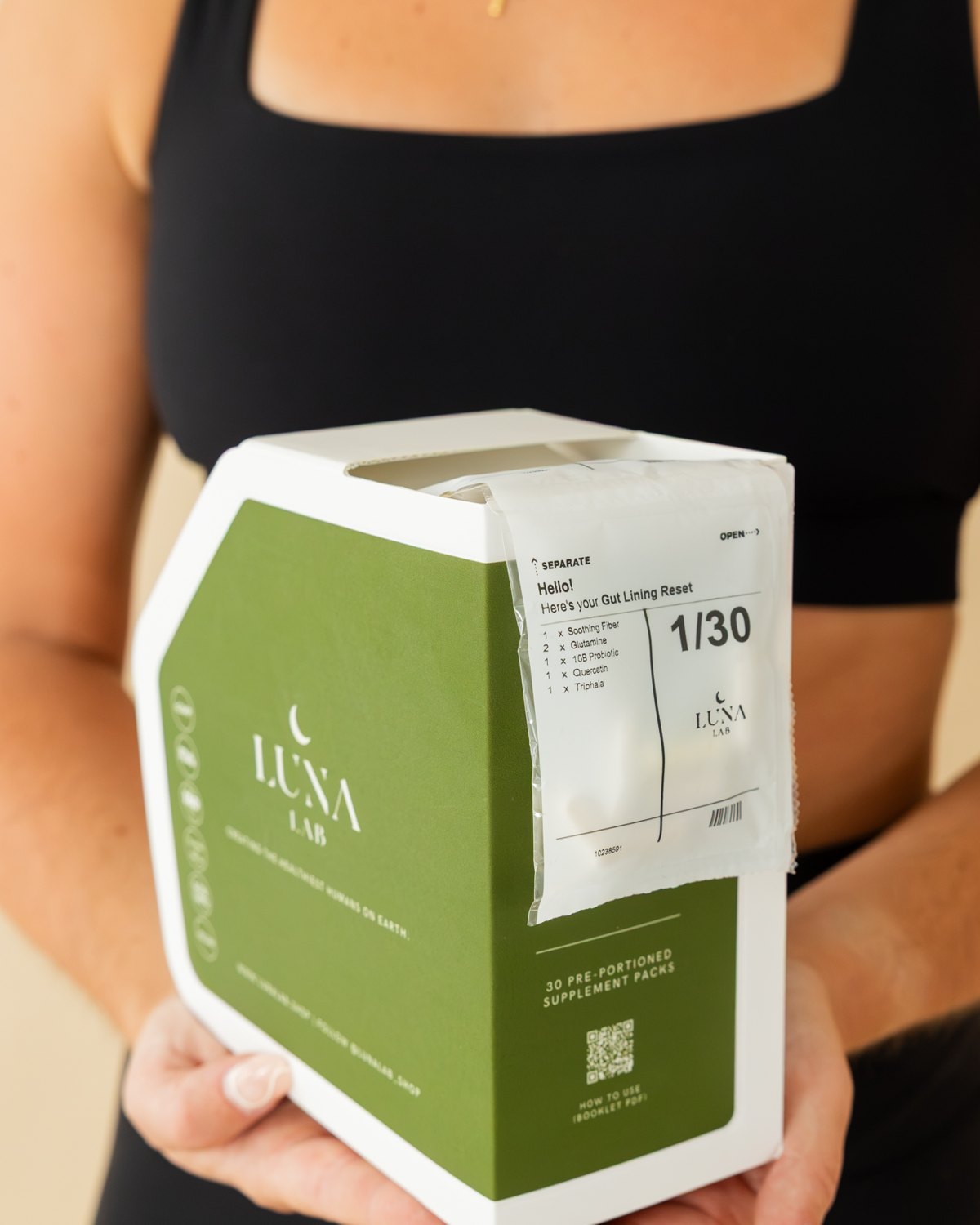 Woman holding the Gut Lining Reset box